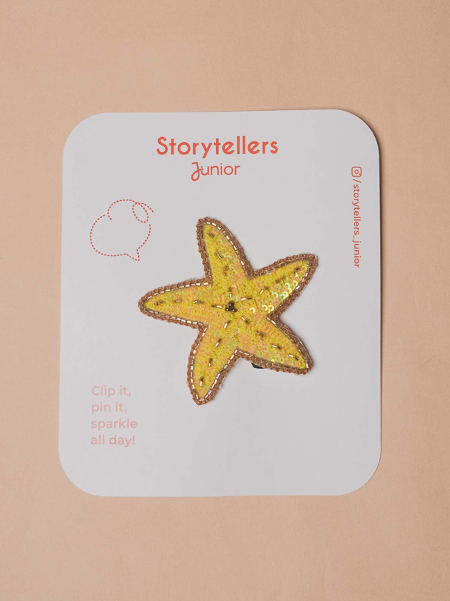 Yellow hand-beaded starfish brooch pin featuring shimmering gold sequin details displayed on a StorytellersJunior product backing card.