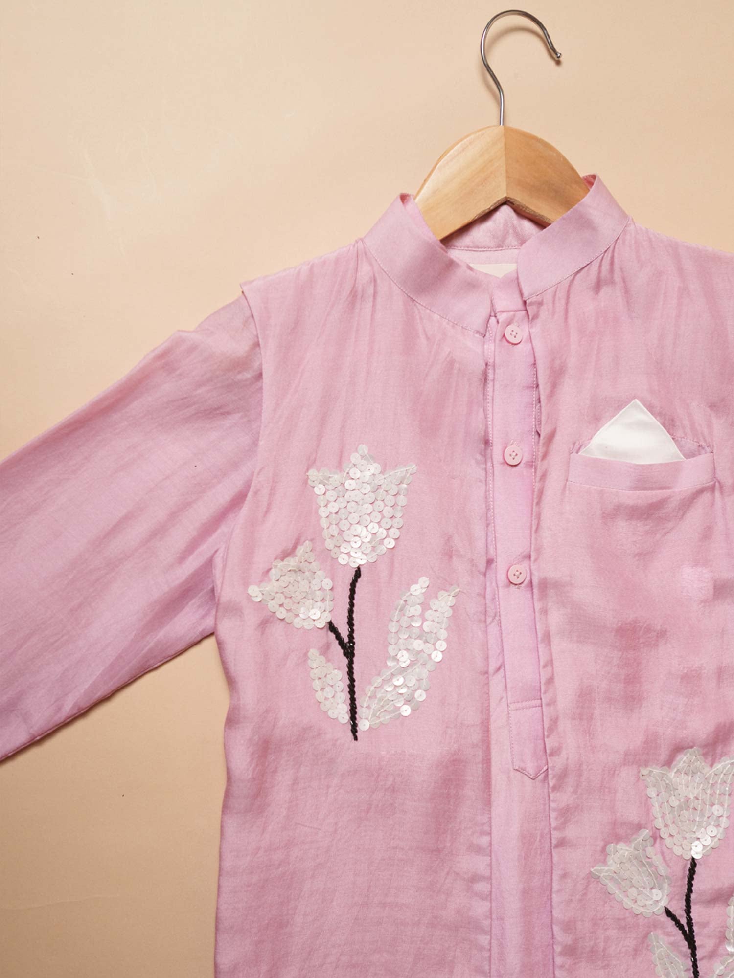 Close-up of hand-embroidered white sequin tulip motifs on the pastel pink muslin Blush Tulip Kurta for boys.