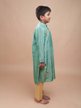 Side view of a boy modeling the Hara Gul Charm Kurta Set, showing the fit of the mint green bamber silk kurta.
