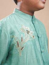 Close-up of the silver and gold sequin floral embroidery on the chest of the mint green bamber silk kurta.