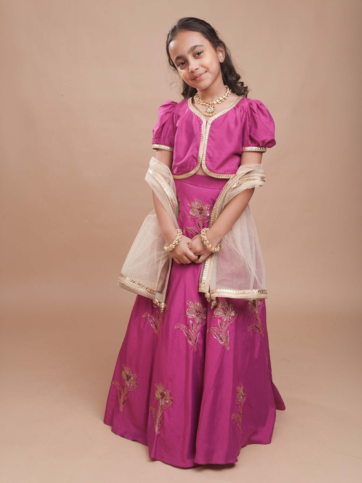 Young girl modeling the Gulnaar Lehenga Set featuring a magenta cotton silk blouse and a flared embroidered lehenga.