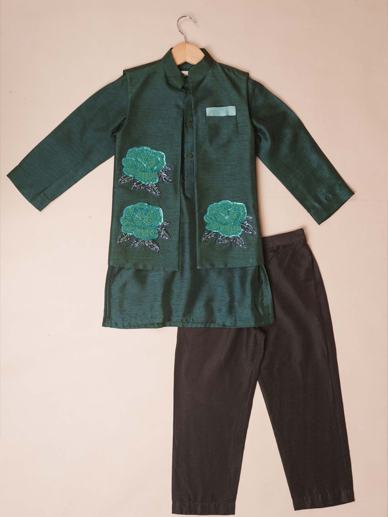 Flat lay view of the Emerald Green Roses Kurta Set featuring a bamber silk jacket with turquoise rose motifs.