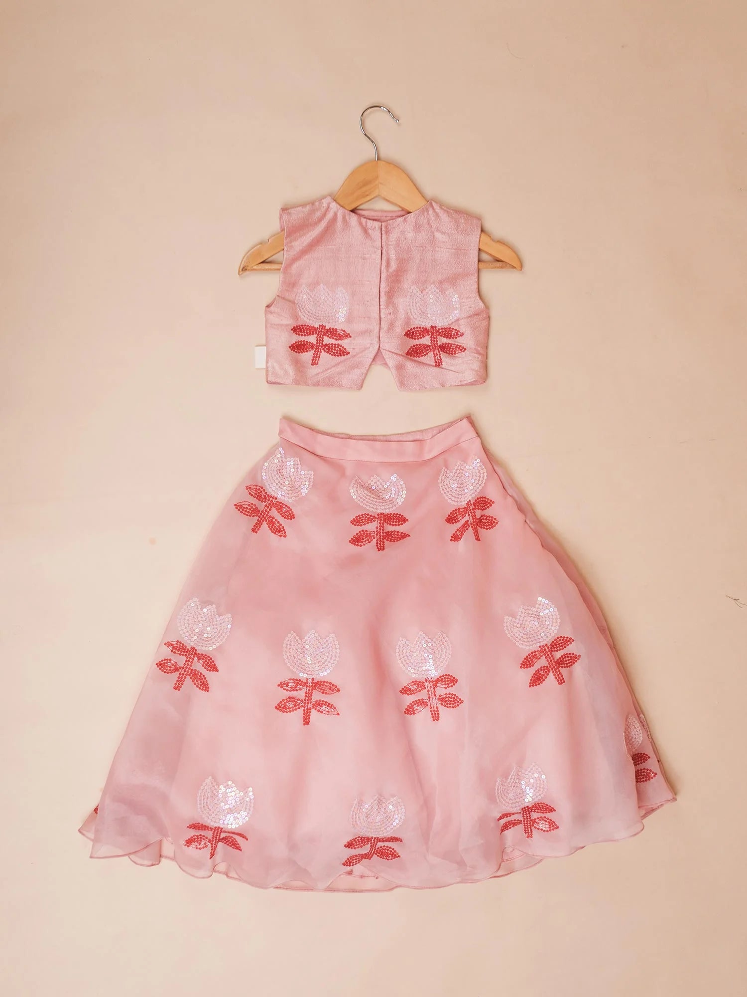 Girl wearing Storytellers Junior Priya Pink Floral Lehenga Set with embroidered lehenga and red dupatta