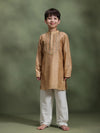 Boy wearing Storytellers Junior Dhruv Beige Taari Work Kurta Set in silk with white pants