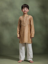 Boy wearing Storytellers Junior Dhruv Beige Taari Work Kurta Set in silk with white pants