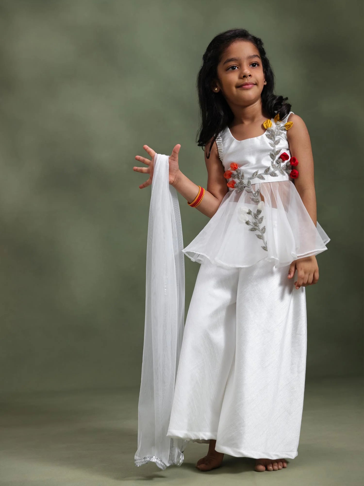 Girl wearing Storytellers Junior Anaya Ivory Blossom Sharara Set with handcrafted floral vine and flower buds