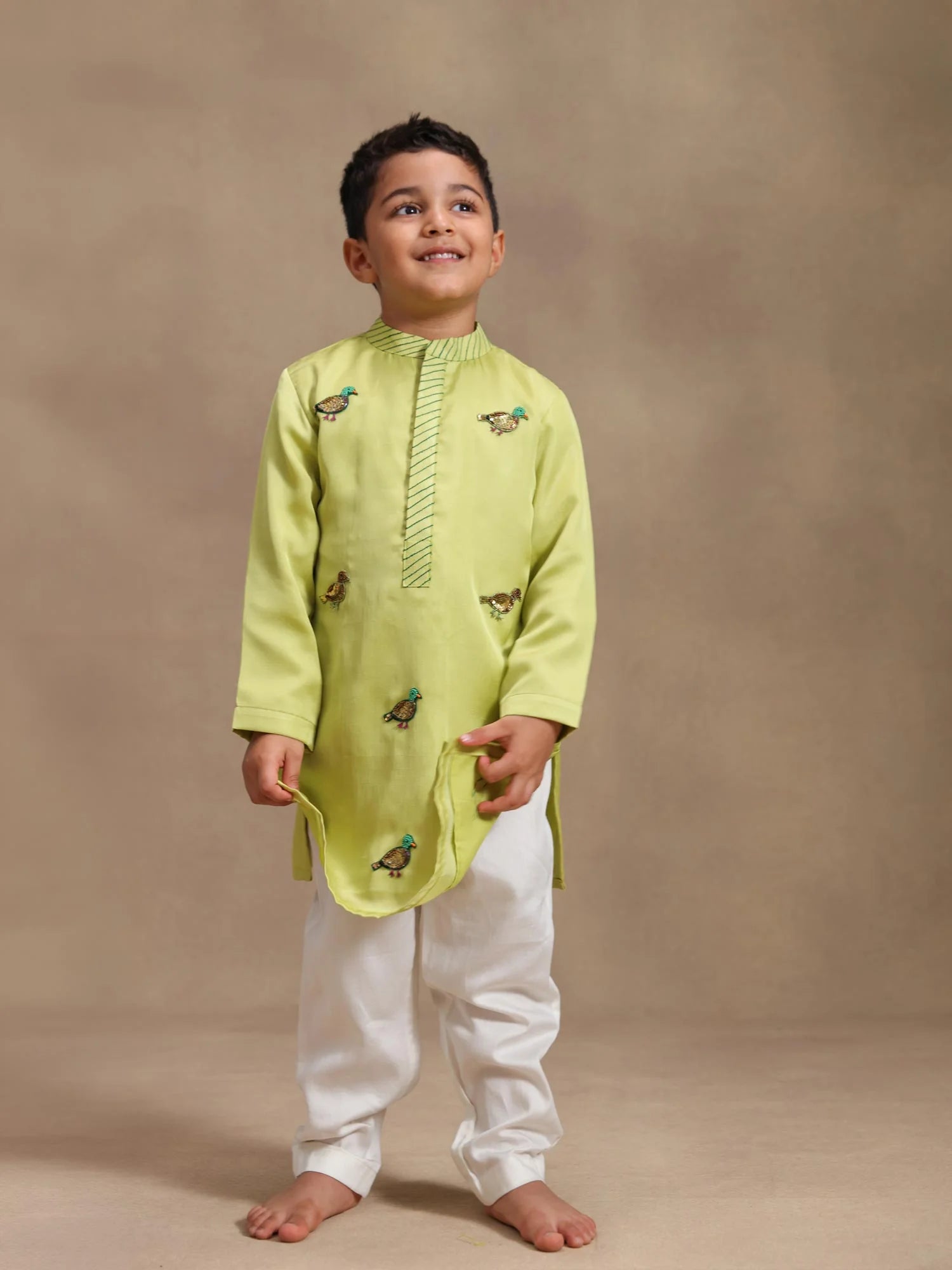 Boy wearing Storytellers Junior Chirag Lime Bird Kurta Set in lime green with handmade bird motifs