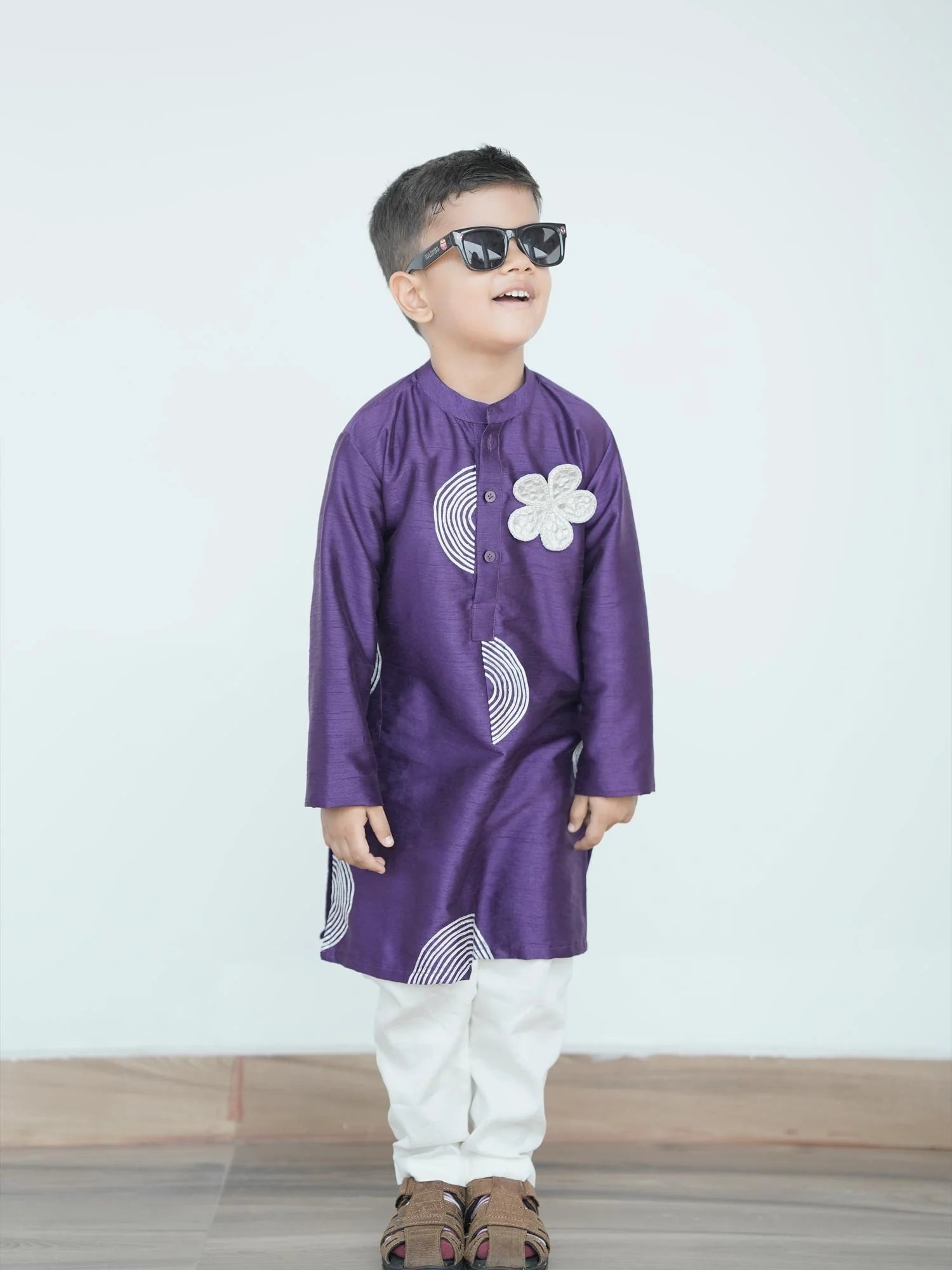 Boy wearing Storytellers Junior Ishan Purple Kurta Pajama Set in royal purple silk