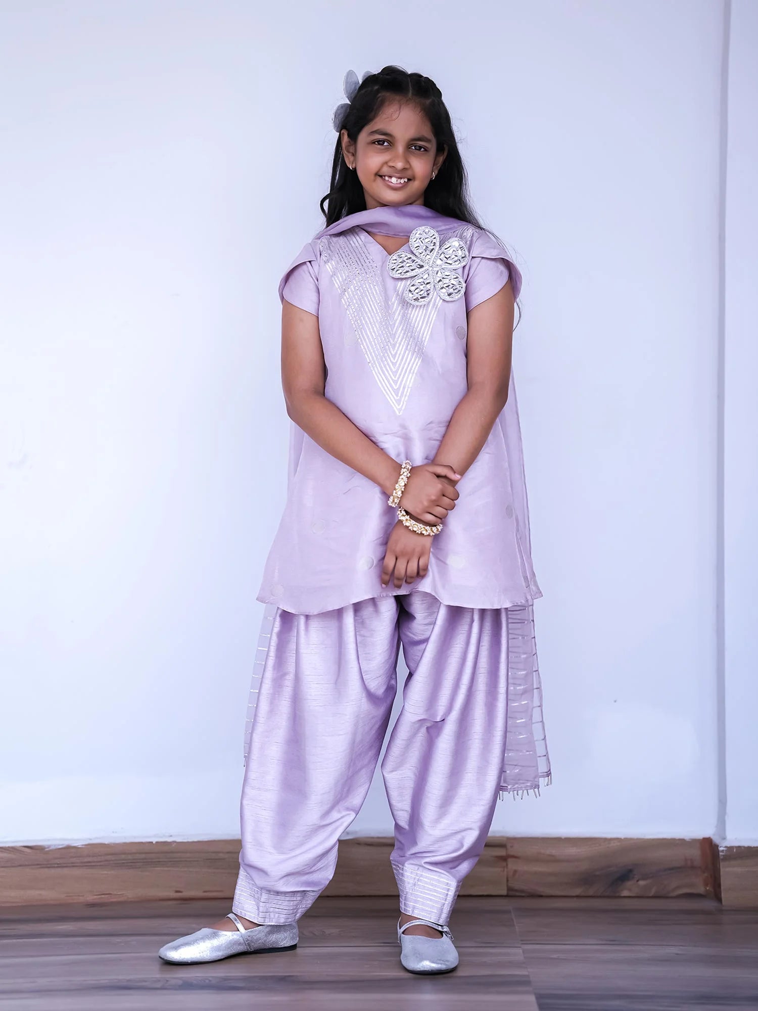 Girl wearing Storytellers Junior Layla Lavender Kurti Salwar Set with handcrafted detailing