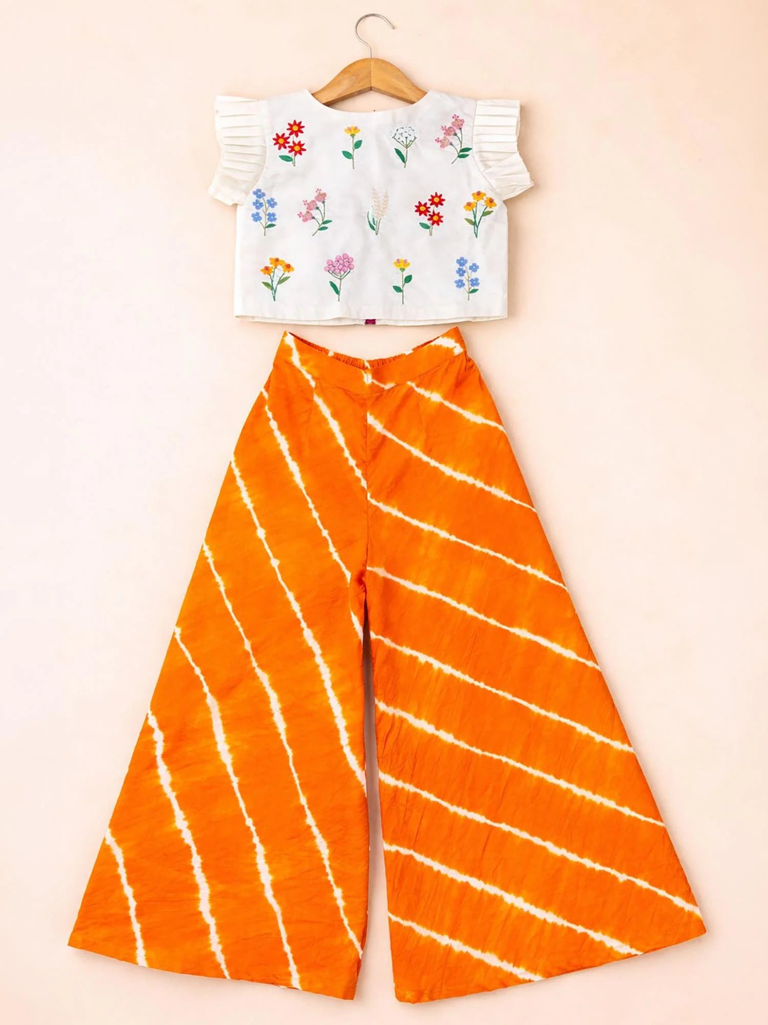 Girl wearing Storytellers Junior Pari Floral Embroidered Palazzo Set in ivory and orange leheriya