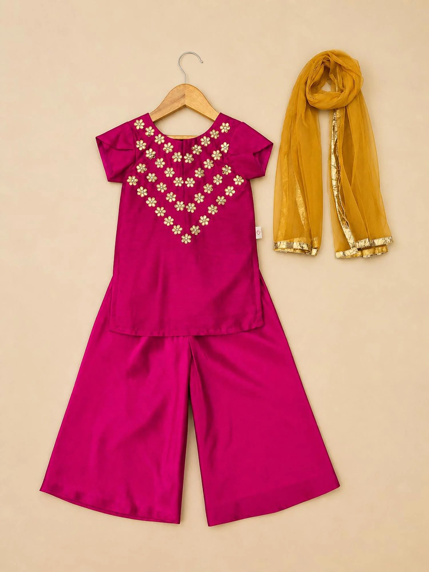 Girl wearing Storytellers Junior Leela Pink Gota Palazzo Set with mustard dupatta