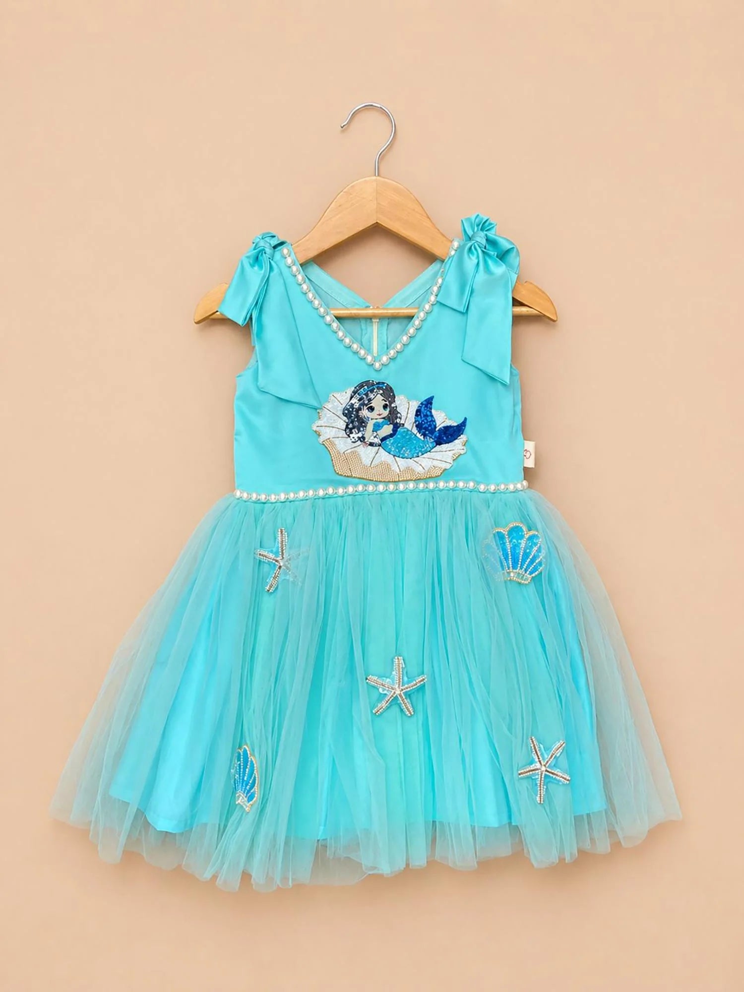 Girl wearing Storytellers Junior Isabelle Princess Party Dress in white organza with castle embroidery