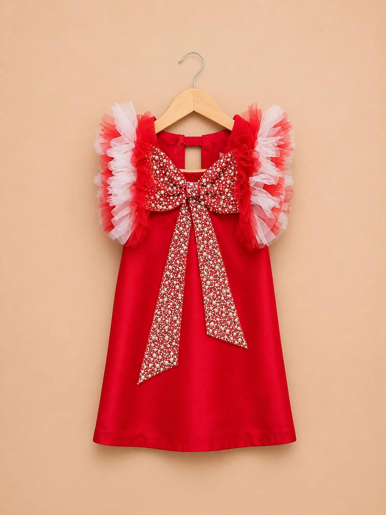 Girl wearing Storytellers Junior Florence Pearl Bow Dress in red with ruffle sleeves